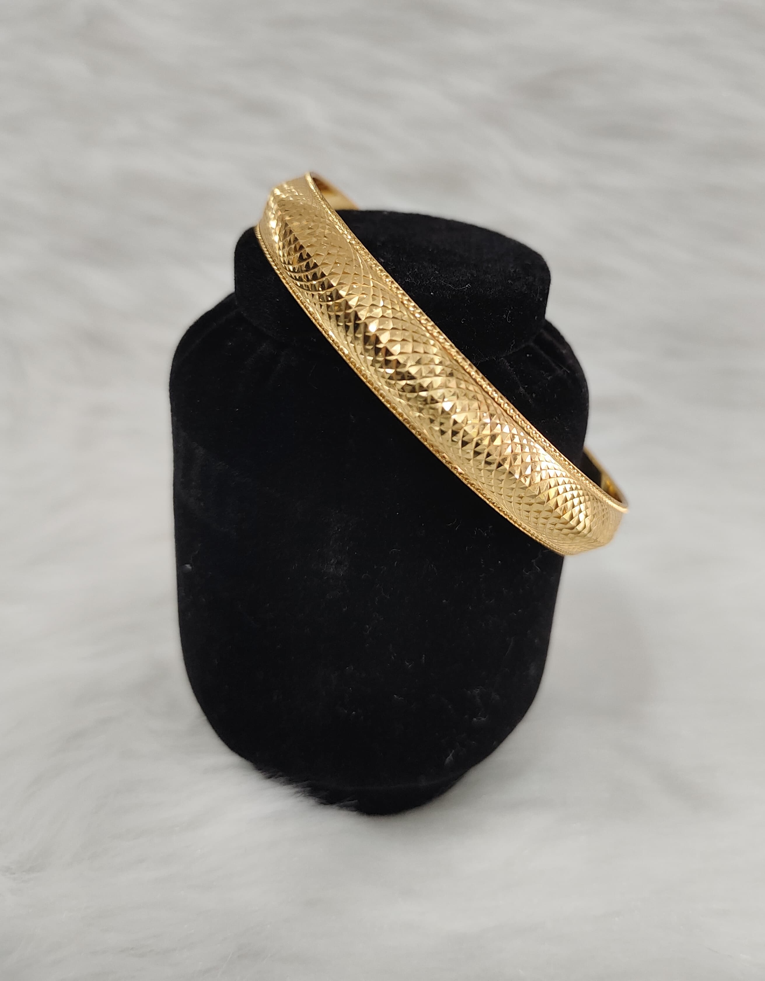 City gold-plated Kada bracelet features a textured, diamond-cut surface pattern view 3