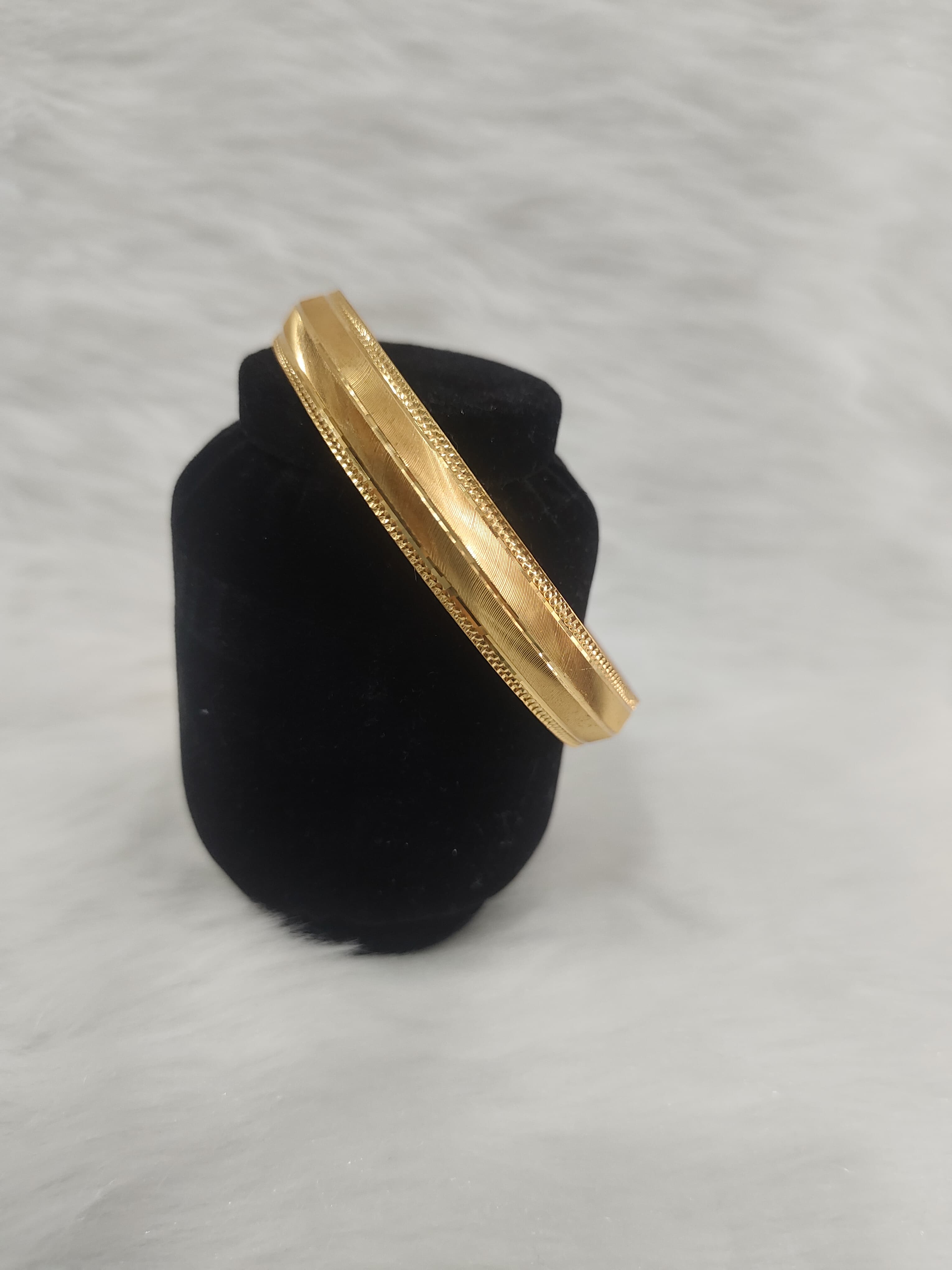Regal 22KT gold plated kada for men features a polished finish with engraved linear textures view 2