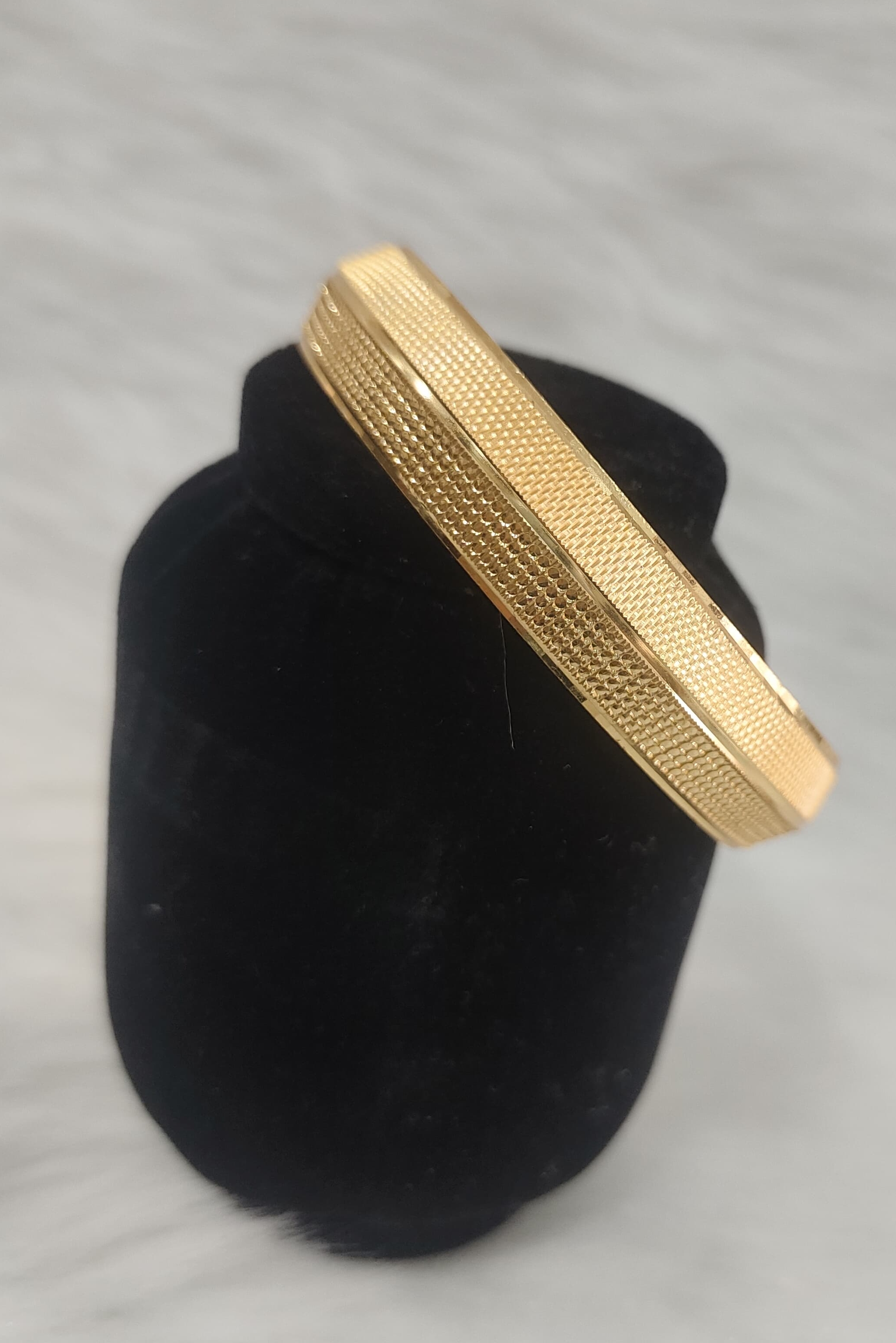 Gold kada resembles the Regal 22KT Gold Plated Kada for Men, featuring a polished finish with finely engraved linear textures view 2