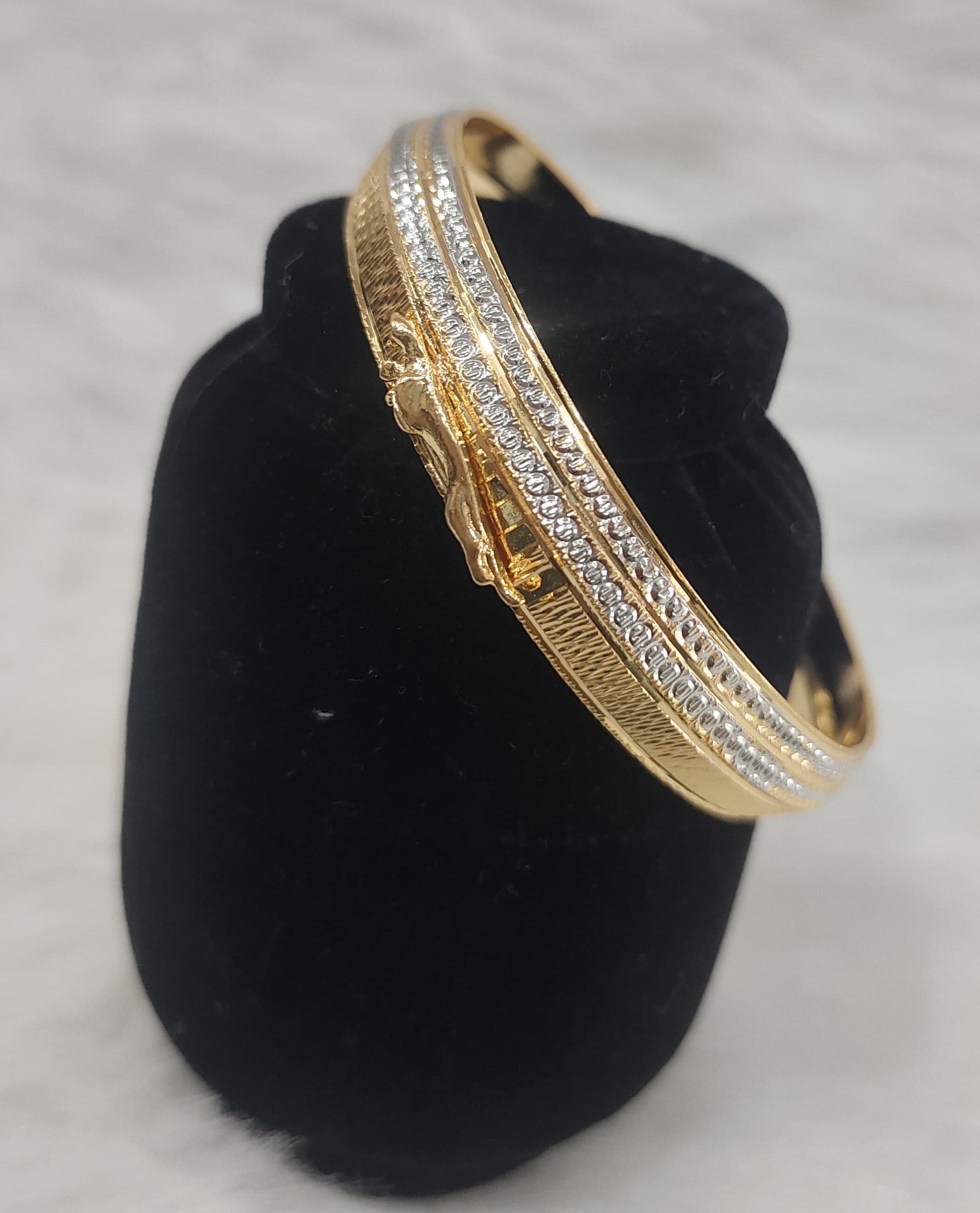 A traditional designer kada featuring a two-tone gold and silver plated design with emosed Jaguar view 2