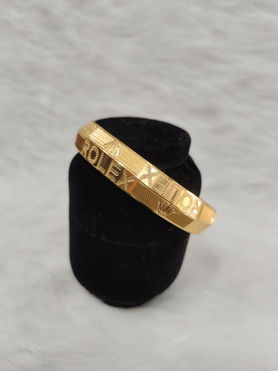 gold-plated Punjabi kada bracelet features bold "ROLEX" lettering and crown logos textured against a matte background view 3