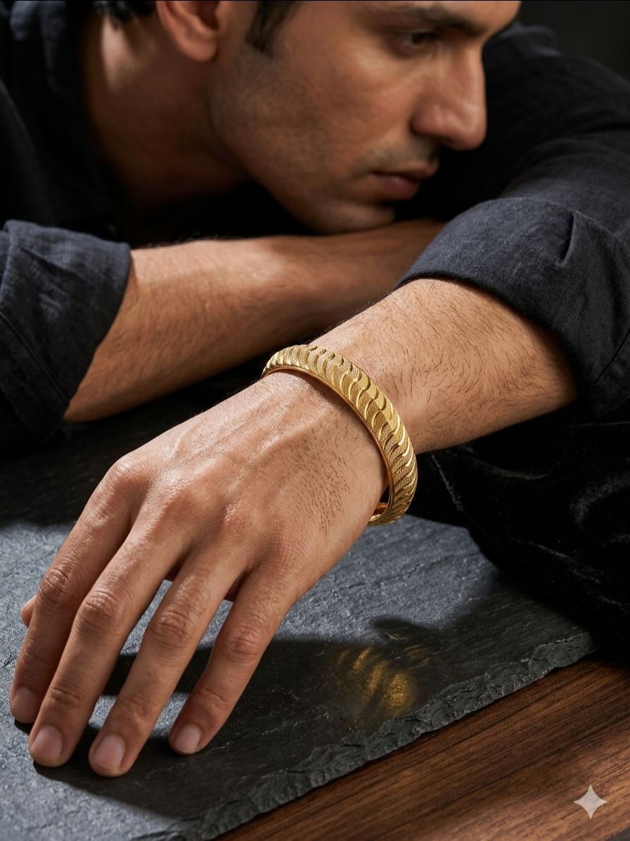 Gold-plated designer kada features a distinctive textured pattern along its entire surface view 2