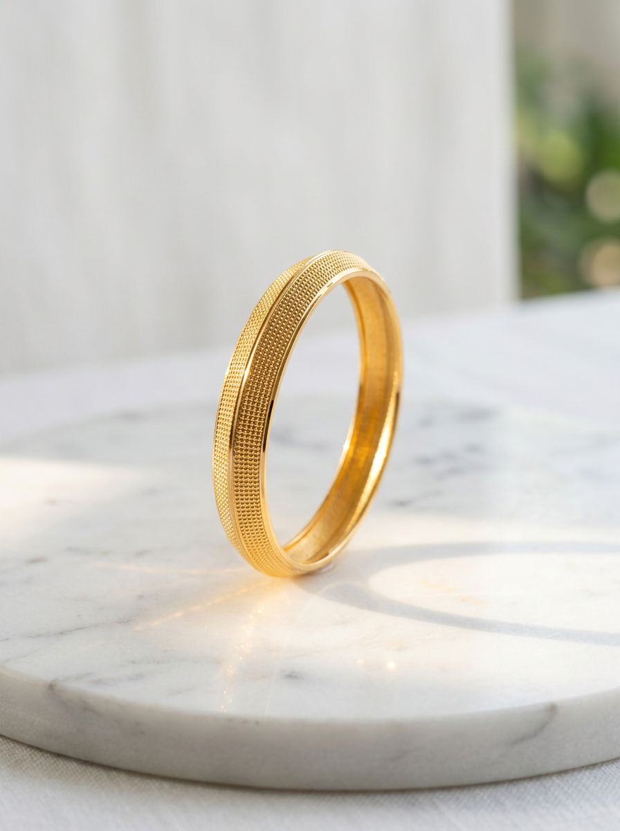Gold kada resembles the Regal 22KT Gold Plated Kada for Men, featuring a polished finish with finely engraved linear textures view 4